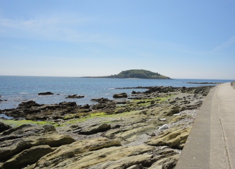 Hannafore Beach with Looe Island Nature Reserve in the background.